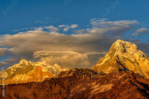 Beautifull cloudy sunrise in the mountains with snow ridge