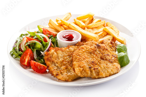 Fried pork chop, French fries and vegetables 