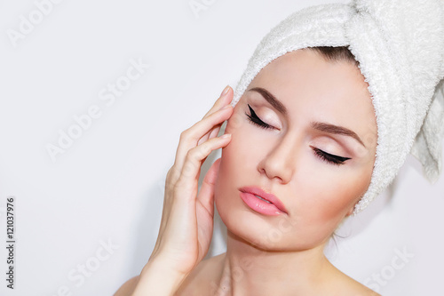Beautiful natural girl woman after cosmetic procedures , facelift , facial massage , visit a beautician , massage lines. Beautiful woman with a towel on his head. Beautiful female.