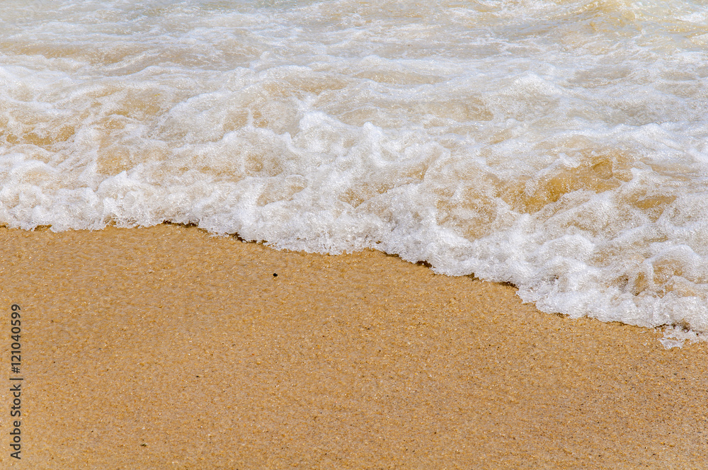Foam wave on sea close with beach background Foam wave on sea close with beach background