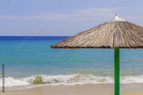 Red umbrellaon beach with sea background