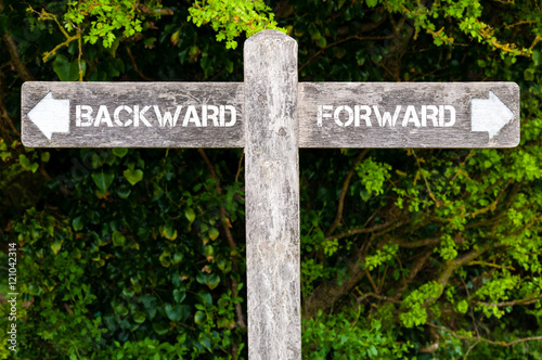 BACKWARD versus FORWARD directional signs photo