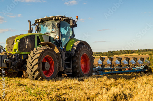 Agriculture plowing tractor on wheat cereal fields