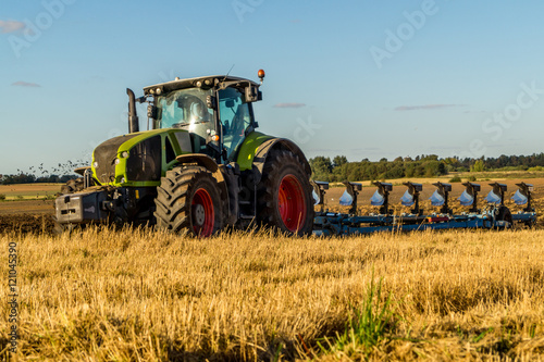 Agriculture plowing tractor on wheat cereal fields