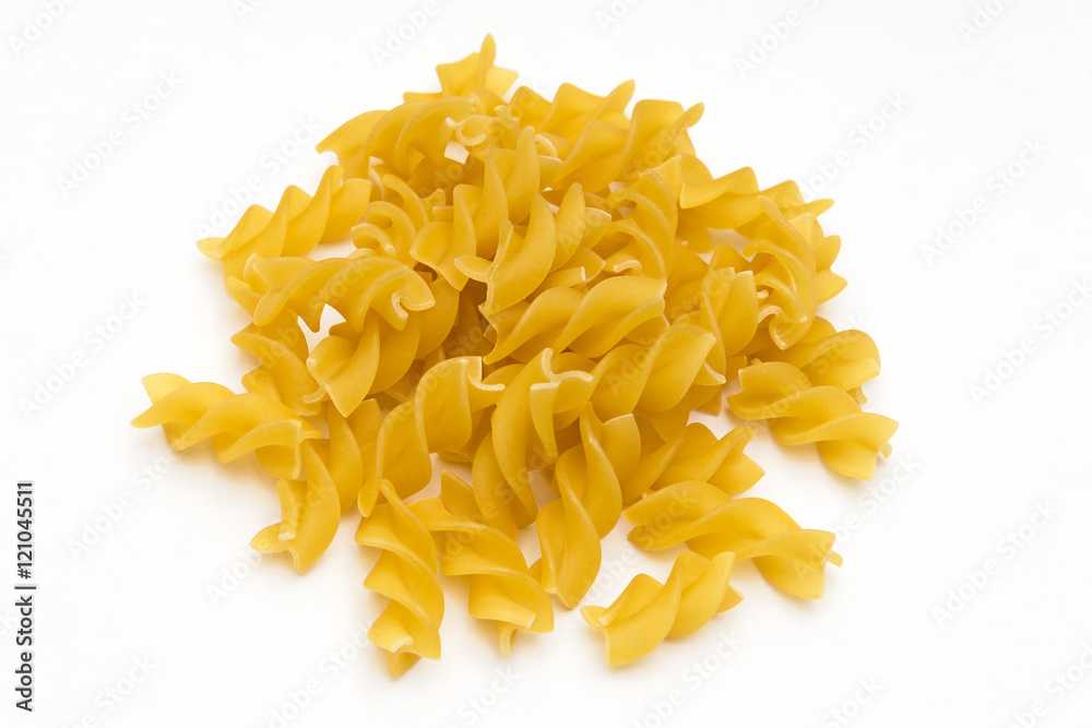 handful of pasta spirals on a white background handful of pasta spirals on a white background