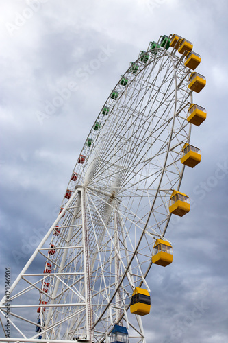 Ferris wheel on the background of clouds