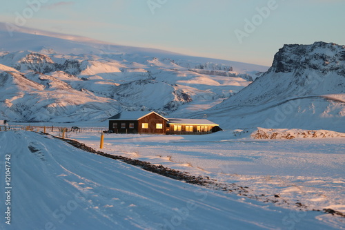 Типичный зимний пейзаж Исландии - одинокие дома посреди гор photo