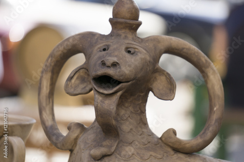Ceramic jug with a goat head