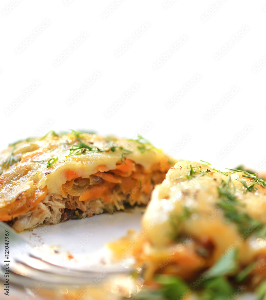 Baked fish with cheese sauce, carrots and onions, decorated with fennel on a white background.