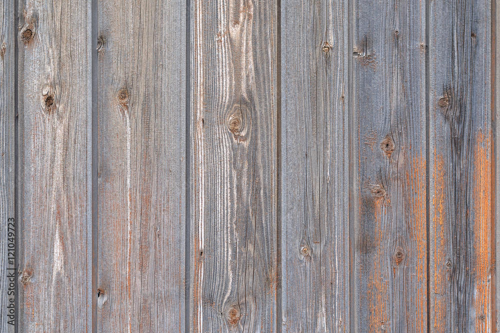 Naklejka premium Old Gray Wooden Fence Partially Painted Orange Paint. Texture, Background Series.