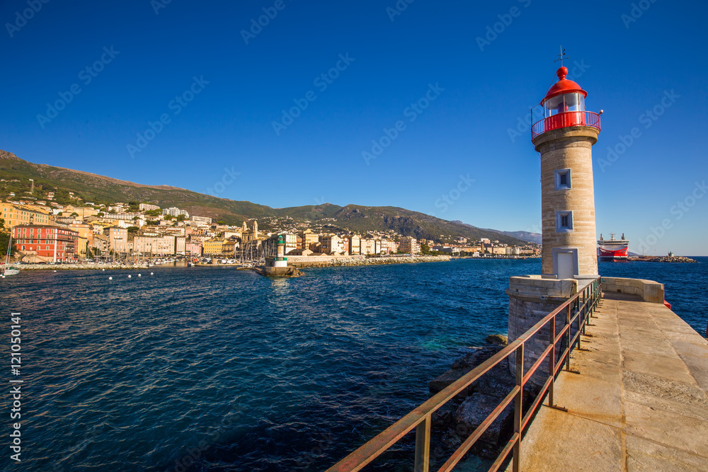 Lighthouse in Bastia harbour with Joannis Babtistes Cathedral
