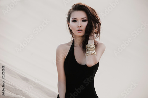 Beautiful sexy asian woman model posing in desert