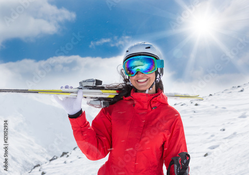 A female skier on the piste.