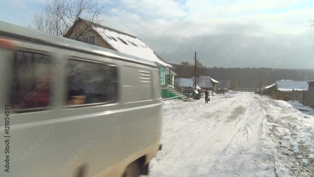 Village on the Hill. Snow Covered. Cloudy Sky. Car Passing By. Man Stepping on the Road. Wide Shot Village on the Hill. Snow Covered. Cloudy Sky. Car Passing By. Man Stepping on the Road. Wide Shot