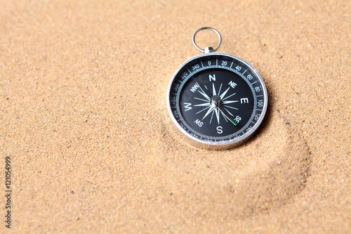 Compass on the sea sand