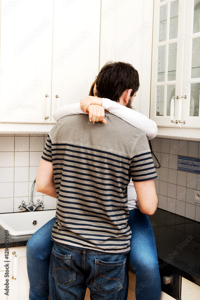Romantic couple hugging in the kitchen. Romantic couple hugging in the kitchen.