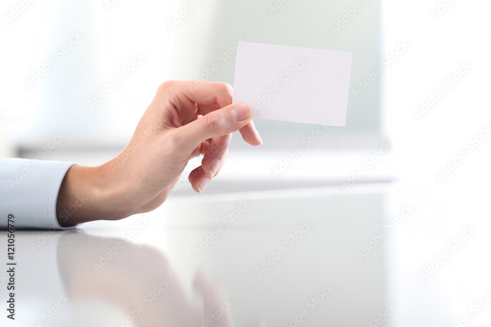 Hand hold blank business card, on desk Hand hold blank business card, on desk