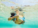 Child snorkeling in clear water