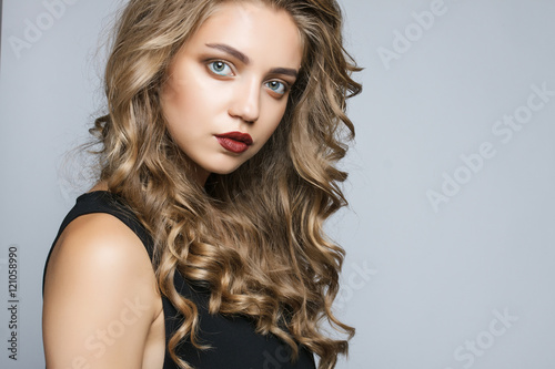close-up portrait of a beautiful girl in the studio on a gray ba