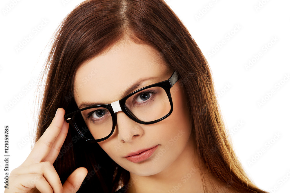Young woman holding her glasses Young woman holding her glasses