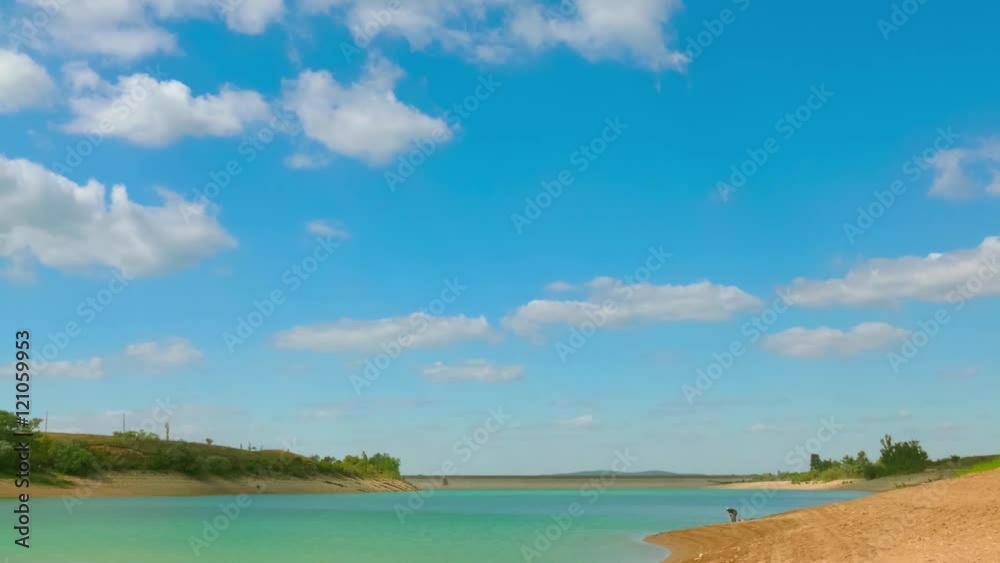 Blue lake / Scenic blue lake with white clouds on the background, time-lapse Blue lake / Scenic blue lake with white clouds on the background, time-lapse