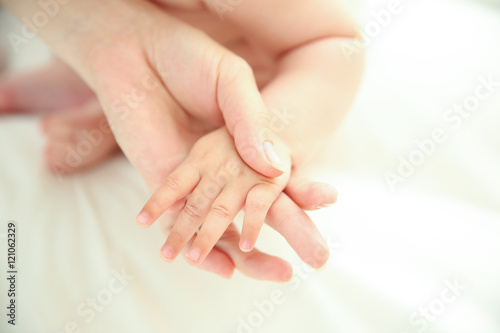 Mother holding baby hand  closeup