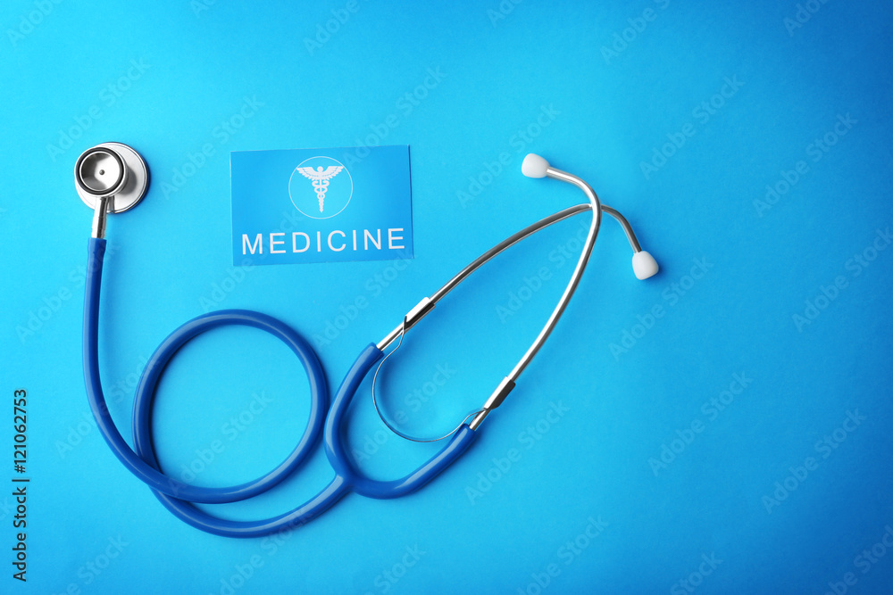 Stethoscope and card on blue background Stethoscope and card on blue background