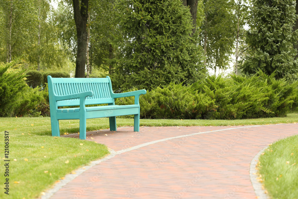 Blue wooden bench in beautiful park