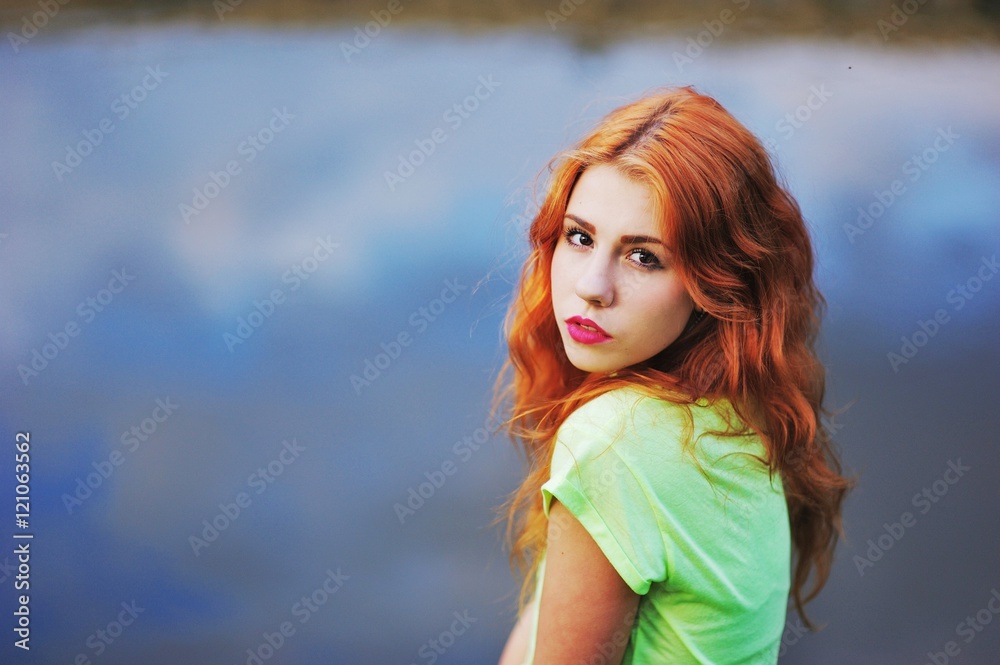 Portrait of a very beautiful brown eyed girls with bright red ha