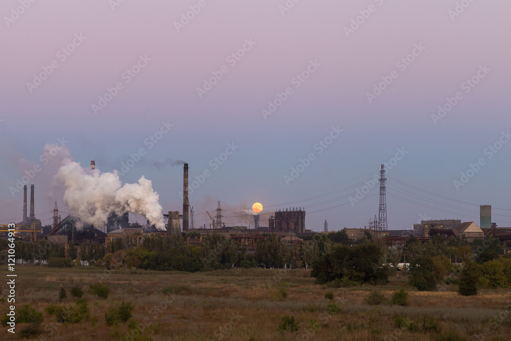 Picture of metallurgical plant and its Smoking chimneys in the background of clear sky Picture of metallurgical plant and its Smoking chimneys in the background of clear sky