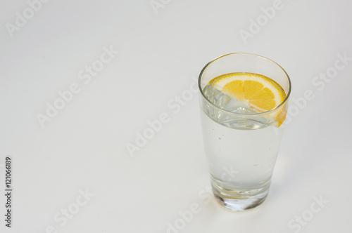 Image of mineral water in glass on a light gray background