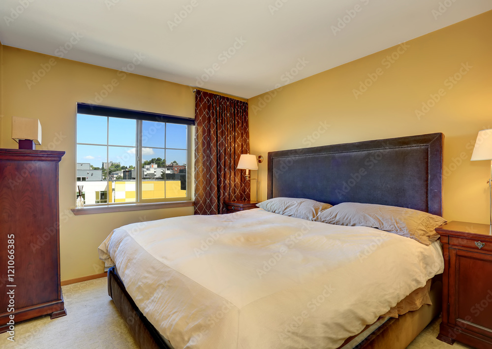Bedroom interior with king size bed and brown curtains. Bedroom interior with king size bed and brown curtains.
