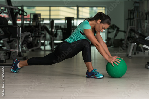 Attractive Woman Doing Stretching With Medicine Ball