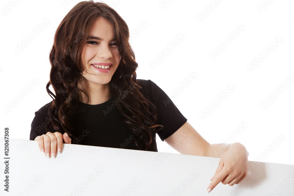 Smiling young business woman holding blank signboard Smiling young business woman holding blank signboard