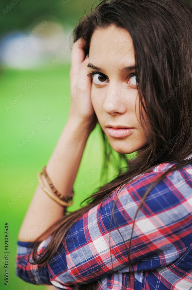 Cute brown eyed girl with long wet hair and droplets of rain on Cute brown eyed girl with long wet hair and droplets of rain on