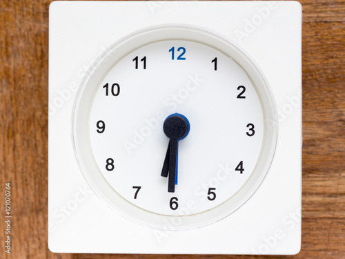 Series of the sequence of time on the simple white analog clock photo