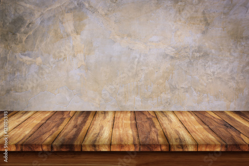 Empty wooden table with bare concrete wall background.