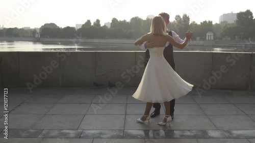 Newlywed couple performing an elegant dance photo