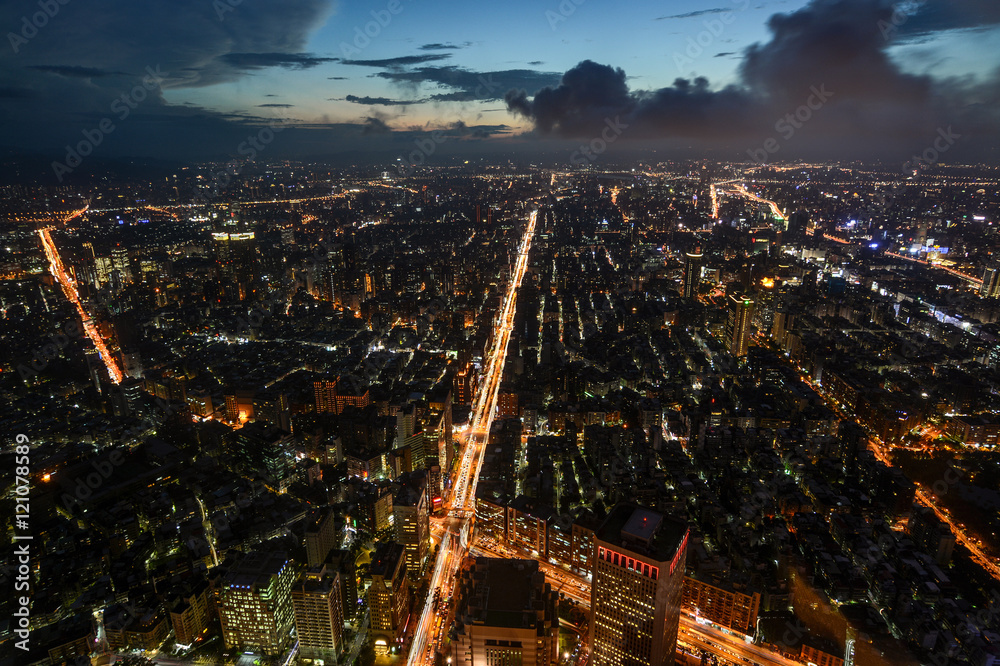 Beautiful aerial night view of Taipei, Taiwan with busy traffic light trails on the Xinyi Road