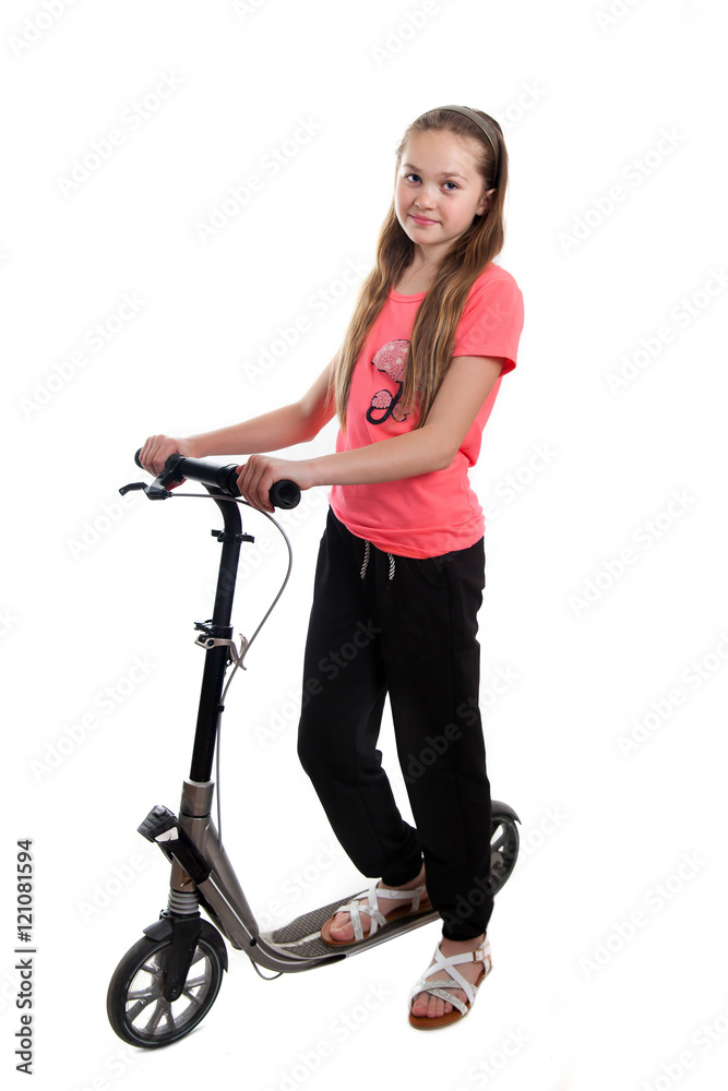 A teenager-girl with a kick scooter in studio A teenager-girl with a kick scooter in studio