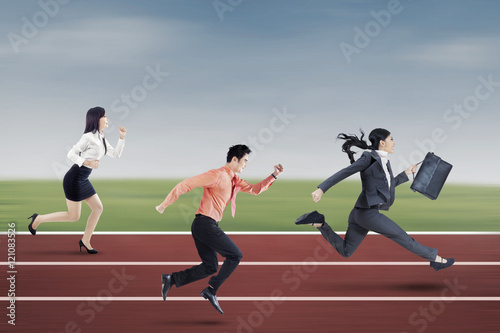 Three entrepreneurs running on the track