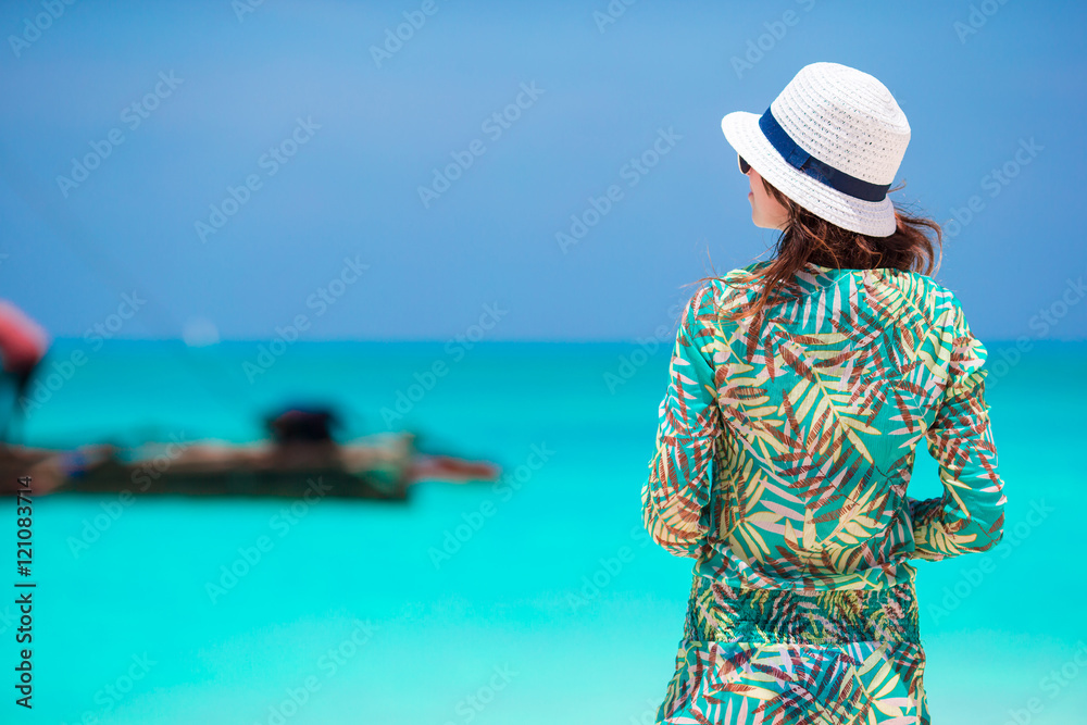 Young beautiful woman on beach during tropical vacation