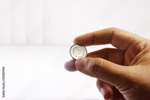 Hand Holding a Coin with White background