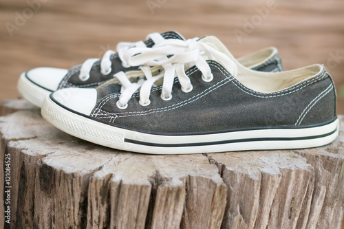 old sneakers on the old tree stump.