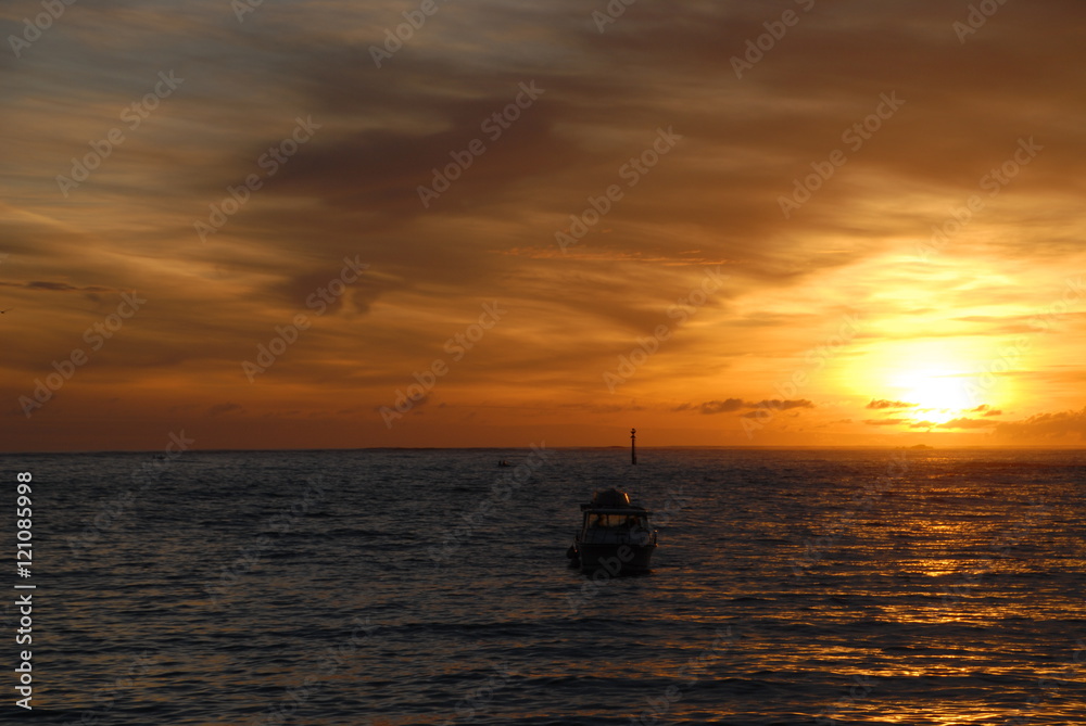 boat at sunset with clouds