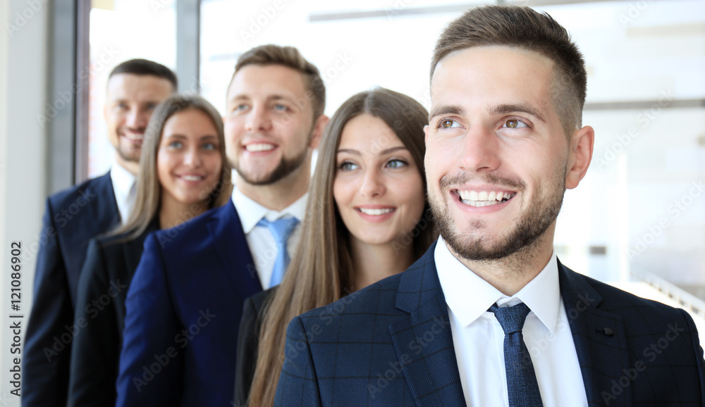 Happy smiling business team standing in a row at office Happy smiling business team standing in a row at office