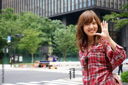 Young Japanese woman saying good-bye to her friend on the street