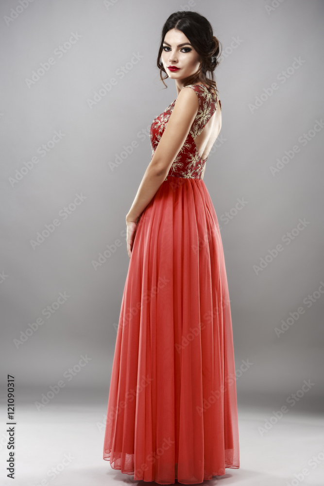Portrait of a beautiful young woman in red dress. Portrait of a beautiful young woman in red dress.