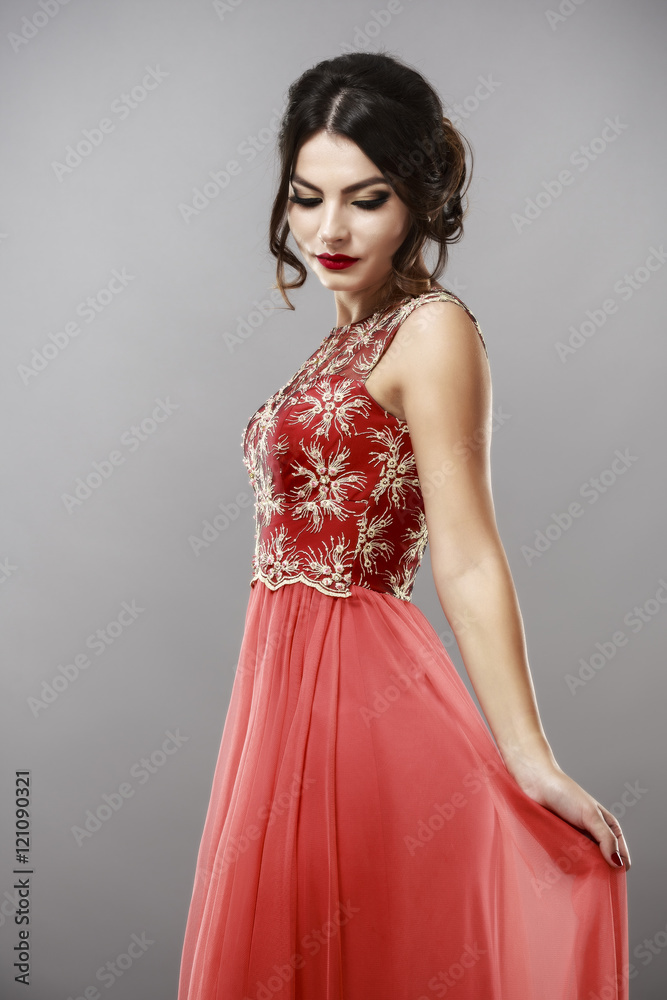 Portrait of a beautiful young woman in red dress. Portrait of a beautiful young woman in red dress.