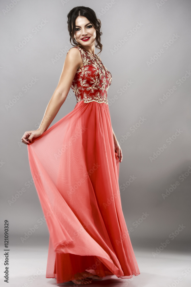 Portrait of a beautiful young woman in red dress. Portrait of a beautiful young woman in red dress.